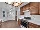 Bright kitchen features wood cabinets, tile countertops, and a breakfast nook with ample natural light at 6150 W Brooks Ave, Las Vegas, NV 89108