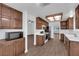 Open kitchen layout with tile countertops, stainless-steel appliances, and wood-style flooring at 6150 W Brooks Ave, Las Vegas, NV 89108