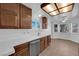 Well-lit kitchen featuring wood cabinets, tile countertops, and stainless-steel appliances at 6150 W Brooks Ave, Las Vegas, NV 89108