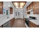 Bright eat-in kitchen features wood cabinetry, stainless steel appliances, and tile flooring at 6150 W Brooks Ave, Las Vegas, NV 89108