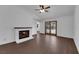 Cozy living room with a brick fireplace, wood-style flooring, and sliding doors leading to the outdoors at 6150 W Brooks Ave, Las Vegas, NV 89108