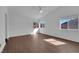 Spacious main bedroom with wood-look floors and two windows for natural light at 6150 W Brooks Ave, Las Vegas, NV 89108