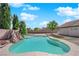 Inviting backyard pool with a rock feature and lush landscaping, ideal for summer relaxation and entertaining at 6150 W Brooks Ave, Las Vegas, NV 89108