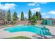 A kidney-shaped pool features waterfalls and lush landscaping at 6150 W Brooks Ave, Las Vegas, NV 89108