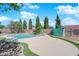 A kidney-shaped pool features waterfalls and lush landscaping at 6150 W Brooks Ave, Las Vegas, NV 89108