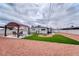 Expansive backyard with lush turf, gravel, covered patio, firepit, and ample seating at 6232 Bristol Way, Las Vegas, NV 89107