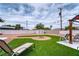 Backyard features turf, a cozy fire pit, gravel landscaping, and comfortable lounge seating at 6232 Bristol Way, Las Vegas, NV 89107