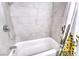 Bathroom with a shower and bathtub with light tile and a fun, colorful shower curtain at 6232 Bristol Way, Las Vegas, NV 89107