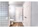Bathroom featuring white subway tile shower and wood-style flooring at 6232 Bristol Way, Las Vegas, NV 89107