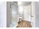 Bathroom with white subway tile shower and wood-style flooring at 6232 Bristol Way, Las Vegas, NV 89107