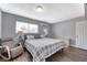 Relaxing bedroom with wood floors, comfy chair, and a cozy bed illuminated by bedside lamps at 6232 Bristol Way, Las Vegas, NV 89107
