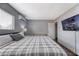 Bedroom with a plaid blanket, wooden floors and TV at 6232 Bristol Way, Las Vegas, NV 89107