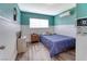 Bedroom with a blue accent wall, TV, and wooden floors at 6232 Bristol Way, Las Vegas, NV 89107