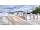 Curb view of the home featuring desert landscaping, and a gated driveway at 6232 Bristol Way, Las Vegas, NV 89107