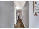 Hallway with wood floors and gray walls showcases access to various rooms with a decorative baby display at 6232 Bristol Way, Las Vegas, NV 89107