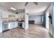 Modern kitchen with stainless steel appliances, granite countertops, and wood floors flowing into living area at 6232 Bristol Way, Las Vegas, NV 89107