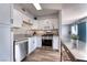 Updated kitchen boasting white cabinets, granite countertops, stainless steel appliances, and wood flooring at 6232 Bristol Way, Las Vegas, NV 89107