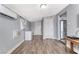 Light-filled living room with wood-look floors, featuring stainless refrigerator, window, and neutral decor at 6232 Bristol Way, Las Vegas, NV 89107