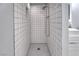 Shower featuring white subway tiles, penny tile floor and built-in shelf at 6232 Bristol Way, Las Vegas, NV 89107