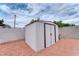Metal storage shed in gravel backyard, providing secure outdoor storage at 6232 Bristol Way, Las Vegas, NV 89107