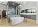 Elegant bathroom with a soaking tub, glass shower, and double sink vanity at 667 Palisade Rim Dr, Henderson, NV 89012