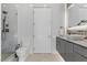 Contemporary bathroom featuring a glass-enclosed shower, stylish vanity, and tiled walls at 667 Palisade Rim Dr, Henderson, NV 89012