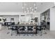 Bright dining room with modern lighting, large table with seating for ten, and an open floor plan at 667 Palisade Rim Dr, Henderson, NV 89012