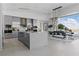 Modern kitchen featuring an island, sleek gray cabinets, stainless steel appliances, and dining at 667 Palisade Rim Dr, Henderson, NV 89012