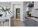 Open concept kitchen with island, sleek cabinets, pantry, and modern design at 667 Palisade Rim Dr, Henderson, NV 89012