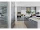 Stylish kitchen with gray cabinetry, a large island, and stainless steel appliances at 667 Palisade Rim Dr, Henderson, NV 89012