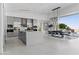 Modern kitchen with a large island, sleek gray cabinetry, and a dining area at 667 Palisade Rim Dr, Henderson, NV 89012