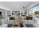 Spacious living room featuring an open kitchen, modern lighting, and comfortable seating arrangement at 667 Palisade Rim Dr, Henderson, NV 89012