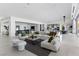 Expansive living room featuring contemporary furniture, a bar, and an open floor plan at 667 Palisade Rim Dr, Henderson, NV 89012