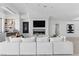 Bright living room with a fireplace, TV, modern decor, and a large white couch at 667 Palisade Rim Dr, Henderson, NV 89012