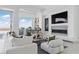 Stylish living room with a stone fireplace, comfortable seating, and access to a bar area and outside views at 667 Palisade Rim Dr, Henderson, NV 89012