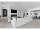 Spacious living room with fireplace, TV, minimalist decor and white modular sofa at 667 Palisade Rim Dr, Henderson, NV 89012