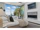 Bright bedroom with a fireplace, balcony access, and a view of the sky at 667 Palisade Rim Dr, Henderson, NV 89012
