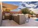 Outdoor kitchen with bar seating, built-in grill, and stylish countertops, ideal for al fresco dining at 667 Palisade Rim Dr, Henderson, NV 89012