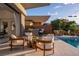 Charming pool area with an outdoor kitchen and lounge area ideal for relaxing and entertaining at 667 Palisade Rim Dr, Henderson, NV 89012