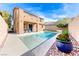 Rear exterior elevation of the home, overlooking the refreshing backyard pool and outdoor living area at 689 Silver Pearl St, Henderson, NV 89002