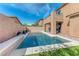 Backyard pool featuring a clean design, with adjacent backyard and the home's rear elevation at 689 Silver Pearl St, Henderson, NV 89002
