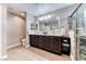 Bathroom featuring double sinks, granite countertops, and a walk-in shower with glass doors at 689 Silver Pearl St, Henderson, NV 89002