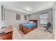 Bedroom features a full sized bed, two windows and carpet at 689 Silver Pearl St, Henderson, NV 89002