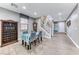 Cozy dining room with stylish decor, wood-look floors, and staircase view at 689 Silver Pearl St, Henderson, NV 89002