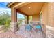 Cozy front porch with brick pillars and an outdoor seating area at 689 Silver Pearl St, Henderson, NV 89002