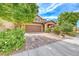 Inviting two-story home with a well-maintained yard and a brick-paved driveway at 689 Silver Pearl St, Henderson, NV 89002