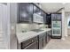 Kitchen features stainless appliances, dark cabinets, and a mosaic tile backsplash at 689 Silver Pearl St, Henderson, NV 89002