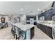Open kitchen with an island, stainless appliances, and seamlessly connects to the dining area at 689 Silver Pearl St, Henderson, NV 89002