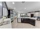Open concept kitchen with sleek stainless appliances flows into the living space at 689 Silver Pearl St, Henderson, NV 89002