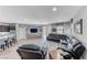 Open-concept living room with tile floors, modern furniture, and backyard access at 689 Silver Pearl St, Henderson, NV 89002